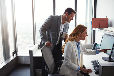 Buy stock photo Cropped shot of man standing behind a woman as she works on her computer