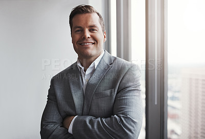 Buy stock photo Shot of a professional businessman standing in an office