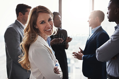 Buy stock photo Cropped portrait of an attractive businesswoman standing with her arms folded during a meeting in the boardroom