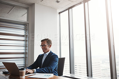 Buy stock photo Cropped shot of a handsome businessman working in his corporate office