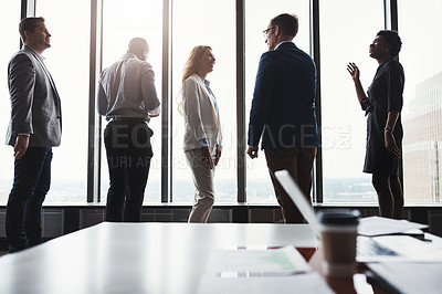 Buy stock photo Low angle shot of a group of corporate businesspeople meeting in their boardroom