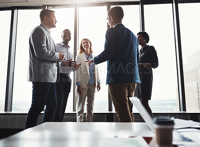 Buy stock photo Low angle shot of a group of corporate businesspeople meeting in their boardroom