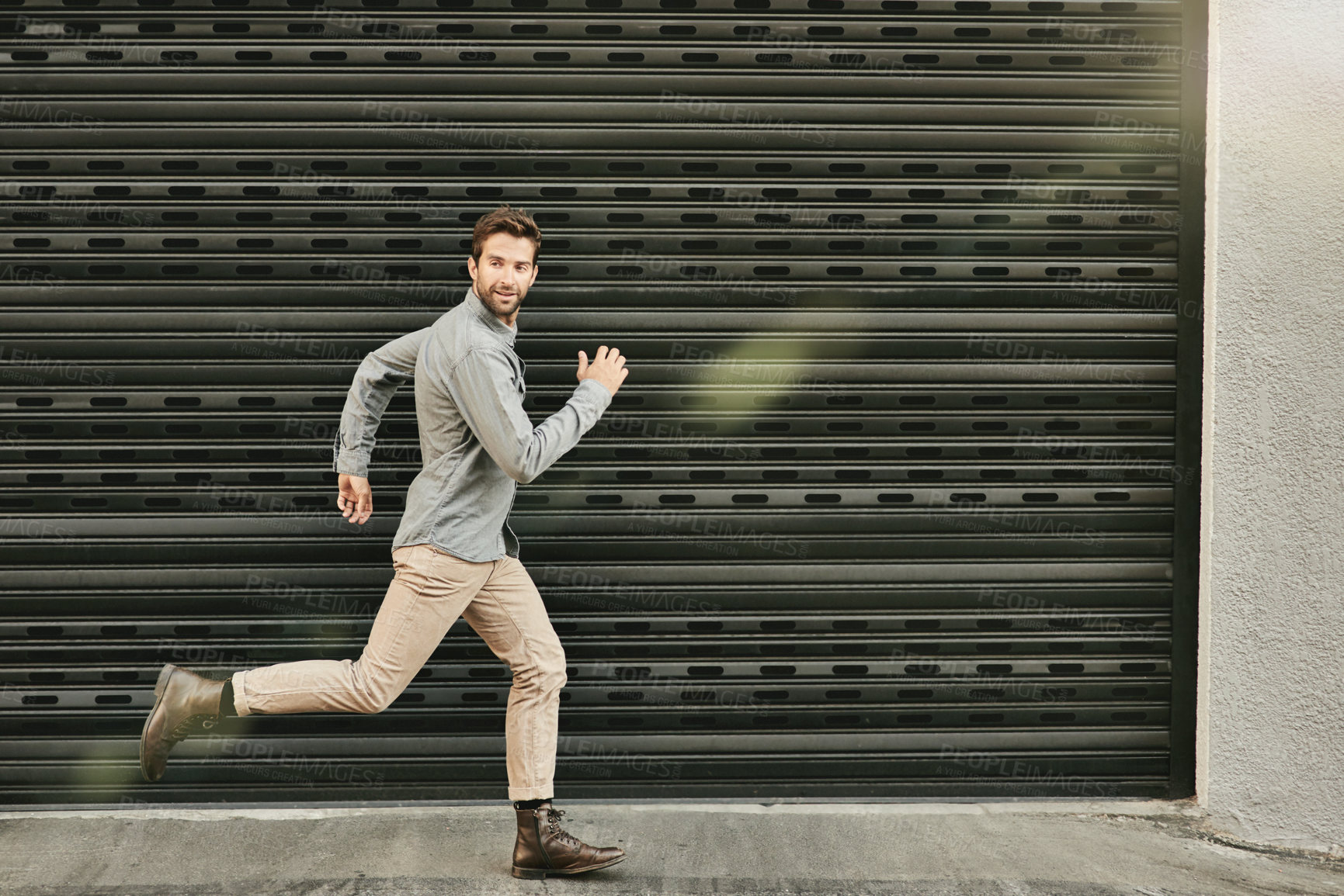 Buy stock photo Man, fashion and running with confidence outdoor on casual, style and elegant for office or job. Clothes, lens flare and smile for dreams or career opportunity, offer and ambition in New York