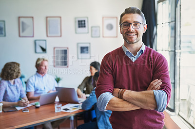 Buy stock photo Portrait of a confident mature man with his team in the background of a modern office