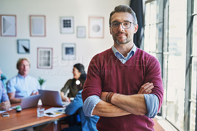 Buy stock photo Portrait of a confident mature man with his team in the background of a modern office