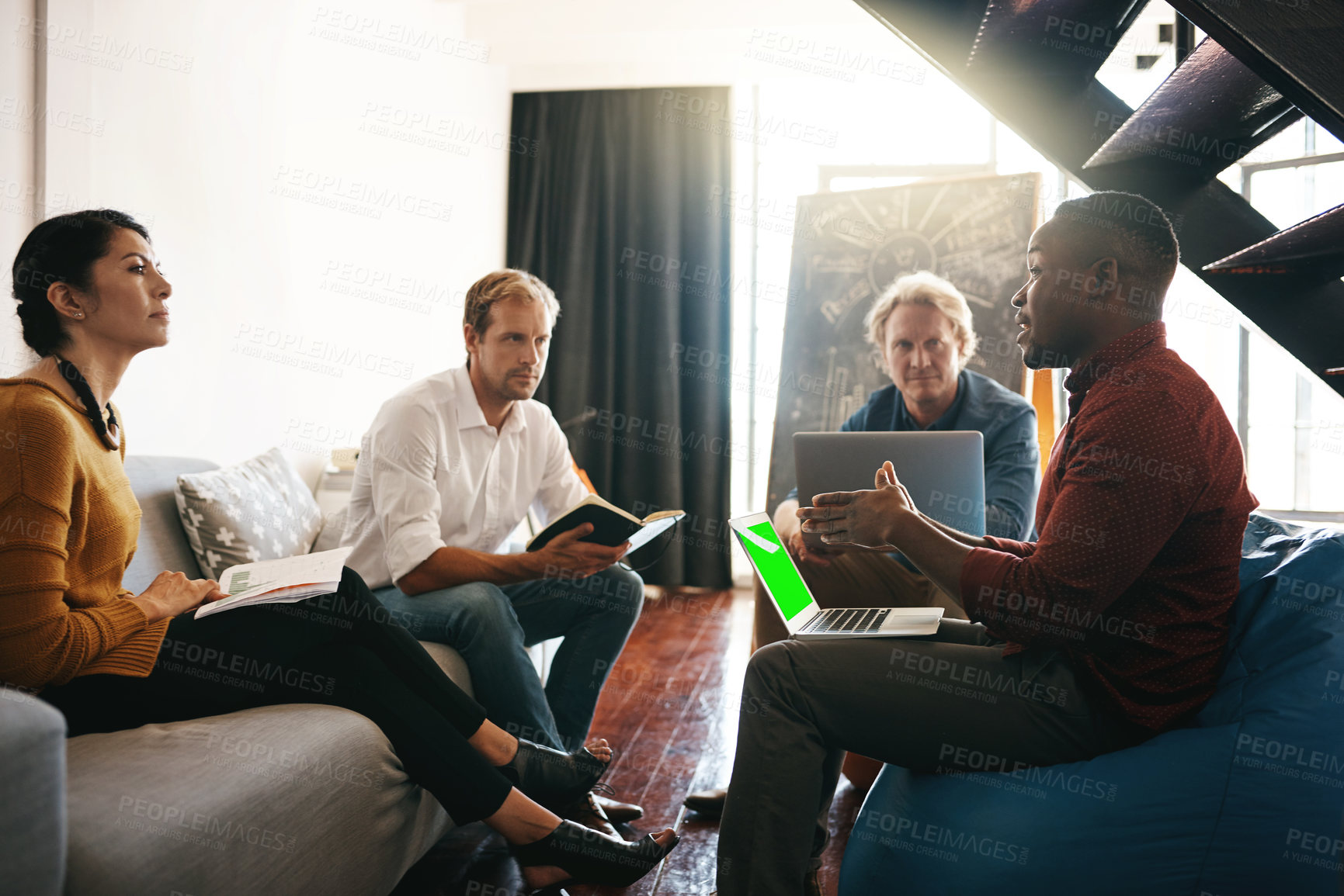 Buy stock photo Shot of a diverse group of designers brainstorming together in an office