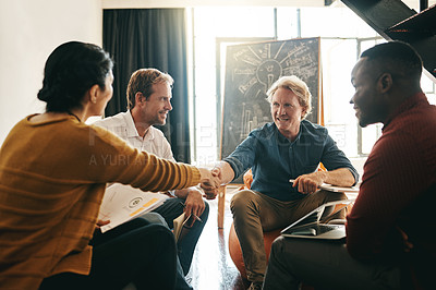 Buy stock photo Shot of designers shaking hands during a meeting in an office