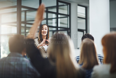 Buy stock photo Woman speaker at seminar, audience with hands up for questions and answers at training presentation or meeting. Feedback, opinion and ideas, group of people at conference, hand in air and question.