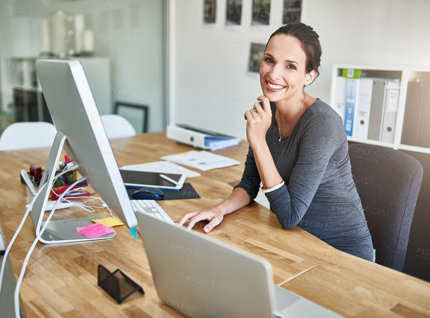 Buy stock photo Cropped portrait of a pregnant businesswoman working on her computer in the office