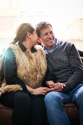 Buy stock photo Mature couple, home and whisper in ear on sofa for love, bonding and gossip with fun. People, relationship and smile or happiness with conversation in living room on couch with hug, care and relax