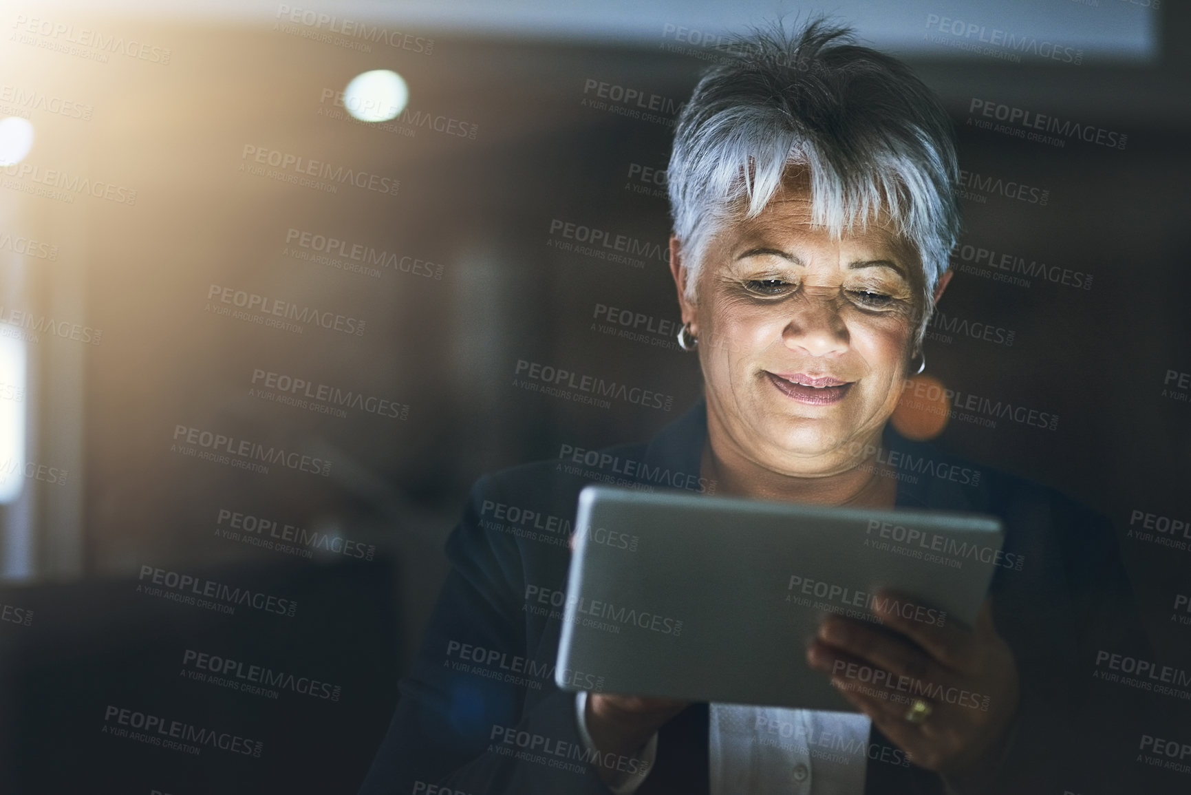 Buy stock photo Mature, business woman and tablet at night as communication specialist in office as employee. Female person, working late and tech for connection, internet or company as professional for email or app