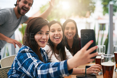 Buy stock photo Shot of a cheerful young group of business work colleagues taking a self portrait together at a restaurant