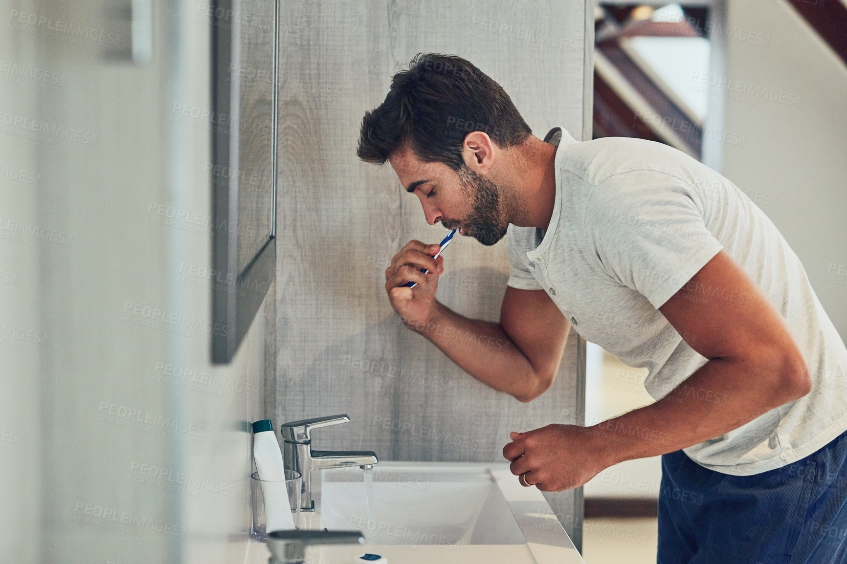 Buy stock photo Dental, sink and brushing teeth with man in bathroom  for cleaning, morning routine or oral hygiene. Smile, cosmetics and health with male person and toothbrush at home for self care, breath or mouth
