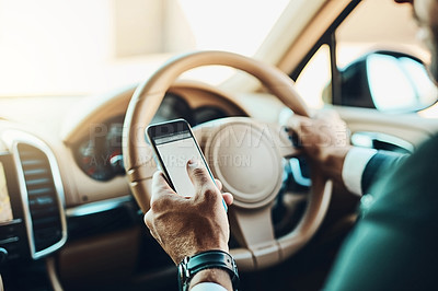 Buy stock photo Cropped shot of an unrecognizable man using a cellphone while driving