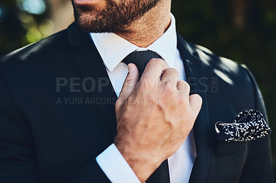Buy stock photo Cropped shot of an unrecognizable man adjusting his tie outside