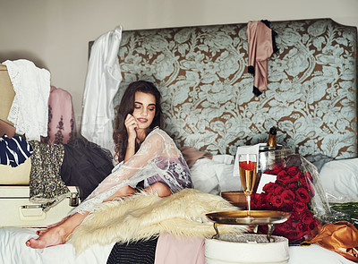 Buy stock photo Shot of a beautiful young woman relaxing on her bed while being surrounded by gifts that she bought herself