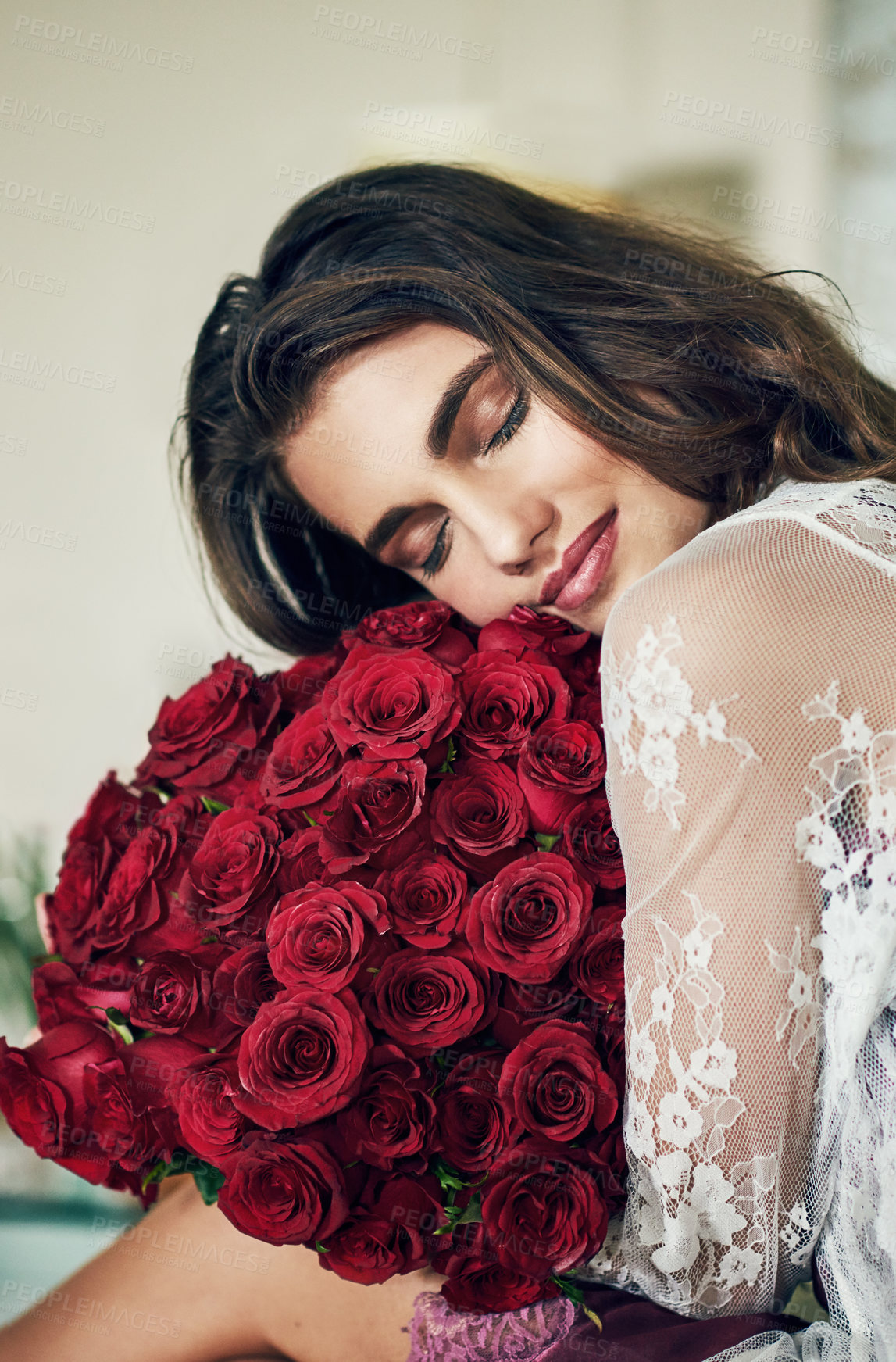 Buy stock photo Woman, home and eyes closed on lingerie with red roses as gift or present for valentines day in France. Smile, female person and sexy or think with bouquet flowers on lace gown in confidence