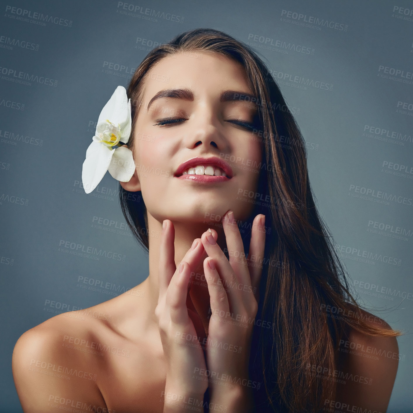 Buy stock photo Face, flower and smile with natural woman in studio isolated on blue background for cosmetics. Aesthetic, beauty and makeup with happy model on space for dermatology, satisfaction or wellness