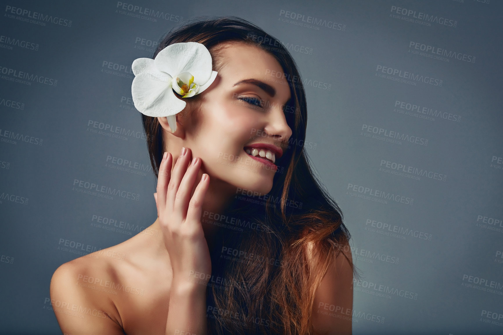 Buy stock photo Beauty, face and flower with natural woman in studio isolated on blue background for skincare. Aesthetic, cosmetics and dermatology with smile of happy model on space for satisfaction or thinking