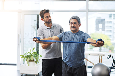 Buy stock photo Physiotherapy, training and band with old man and doctor for stretching, rehabilitation and injury. Medical, healing and healthcare with physiotherapist and patient for consulting, help and fitness
