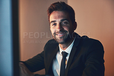 Buy stock photo Cropped portrait of a handsome young businessman working late in the office