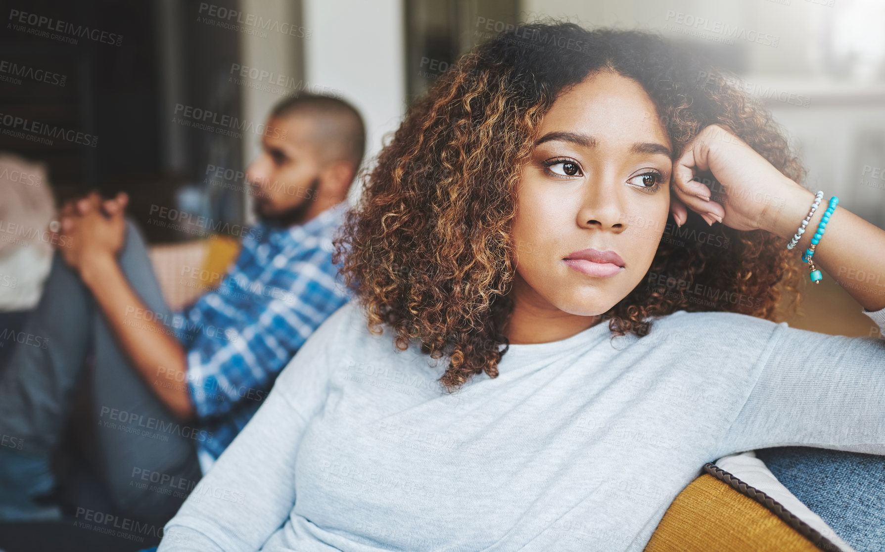 Buy stock photo Unhappy, angry and stressed couple sitting on a sofa together after arguing. Young african american man and woman looking annoyed and ready for divorce while experiencing relationship problems