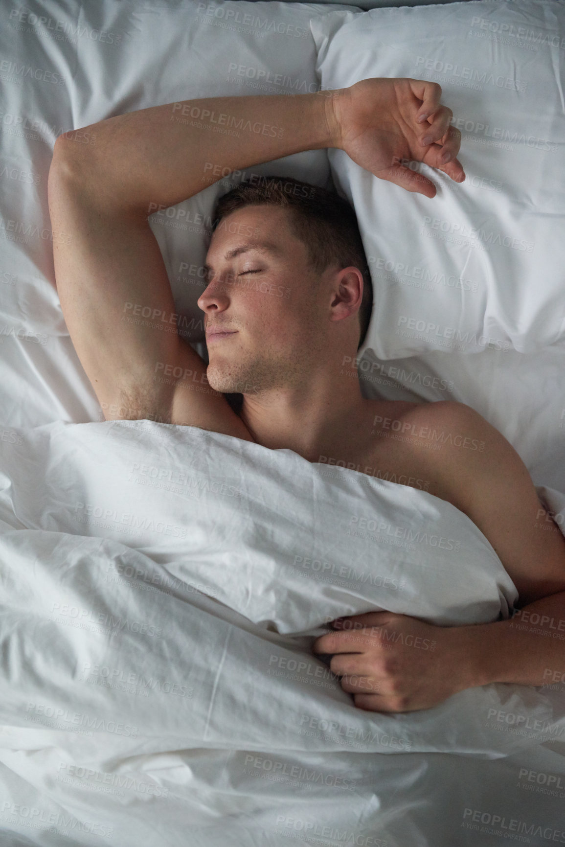 Buy stock photo Cropped shot of a shirtless young man sleeping in his bedroom