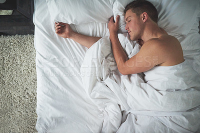 Buy stock photo Cropped shot of a shirtless young man sleeping in his bedroom