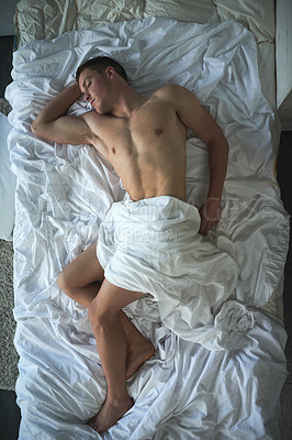 Buy stock photo Shot of a shirtless young man sleeping in his bedroom