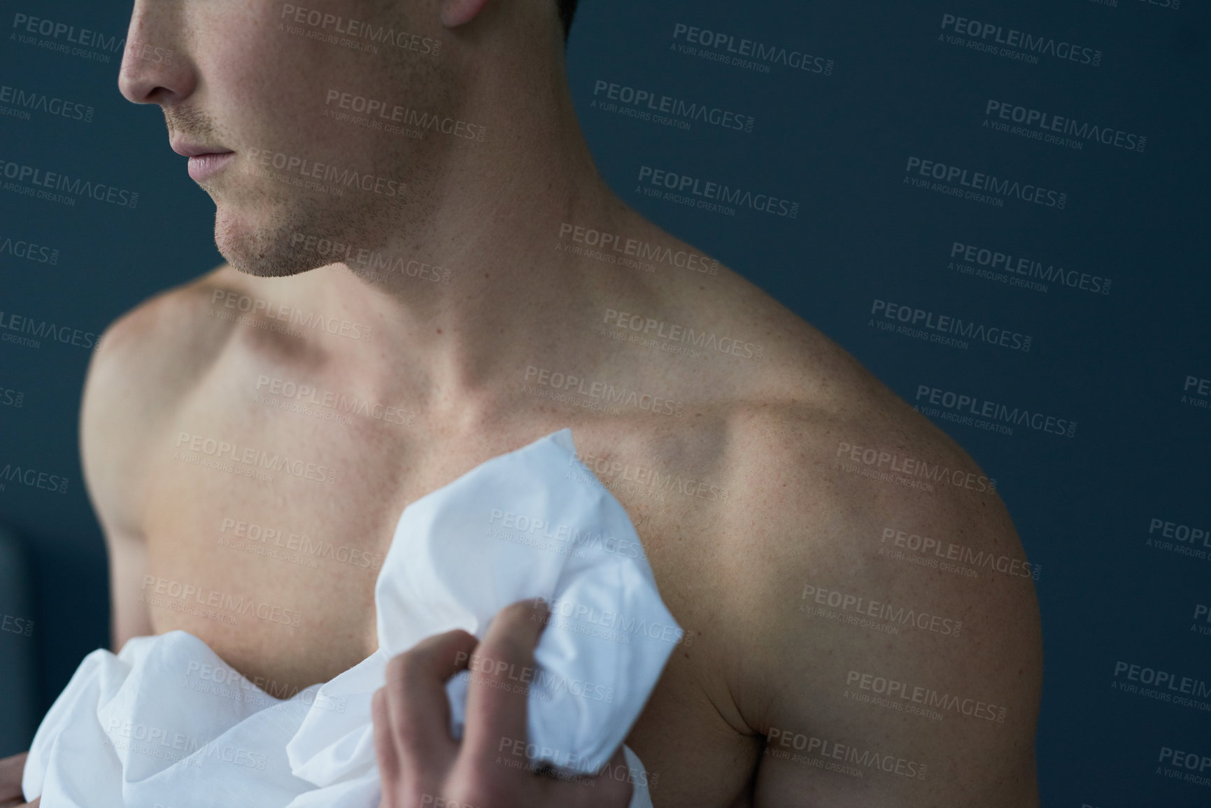 Buy stock photo Man, sheet and naked in home for morning wake up, calm and blanket for comfort by blue background. Male person, nude and relax in bedroom for peace, linen duvet and rest on weekend for lazy sunday