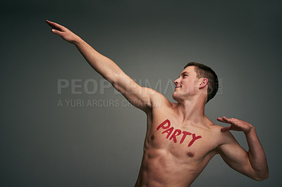Buy stock photo Studio shot of a cheerful young shirtless man standing and flexing his muscles with the word 