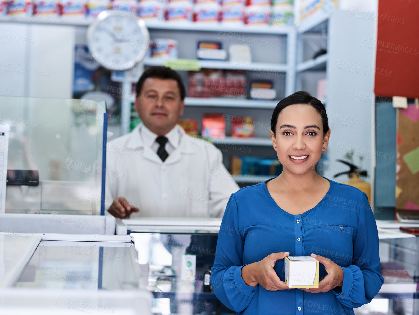 Buy stock photo Shot of a male pharmacist and female customer in a pharmacy
