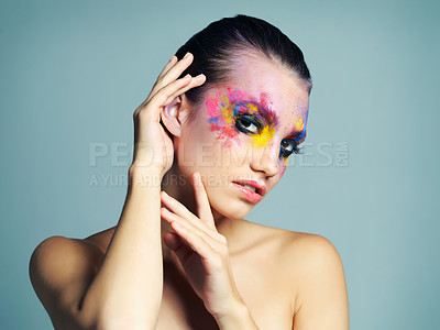 Buy stock photo Colorful, makeup and serious with portrait of woman for creative cosmetics, splash and fantasy. Female person, art and confidence with face paint for beauty, artistic and shine by studio background