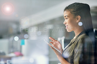 Buy stock photo Shot of a young businesswoman using a tablet at the office