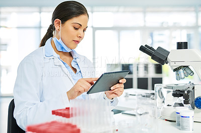 Buy stock photo Shot of a young scientist using a digital tablet in a lab