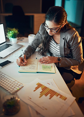 Buy stock photo Shot of a young businesswoman working late in the office