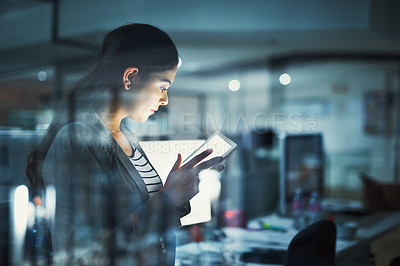 Buy stock photo Shot of a young businesswoman working late in the office