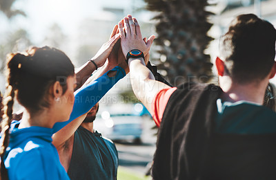 Buy stock photo Shot of young athletes running on the Cropped shot of a fitness group high-fiving before a run