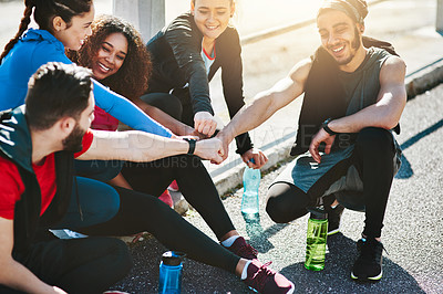Buy stock photo Shot of a fitness group motivating each other before a run