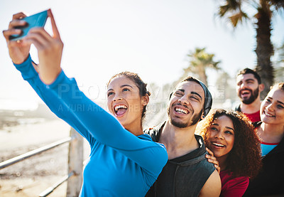 Buy stock photo Cropped shot of a fitness group taking a selfie while out for a run on the promenade
