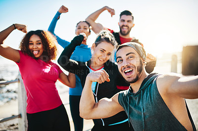 Buy stock photo Cropped shot of a fitness group taking a selfie while out for a run on the promenade