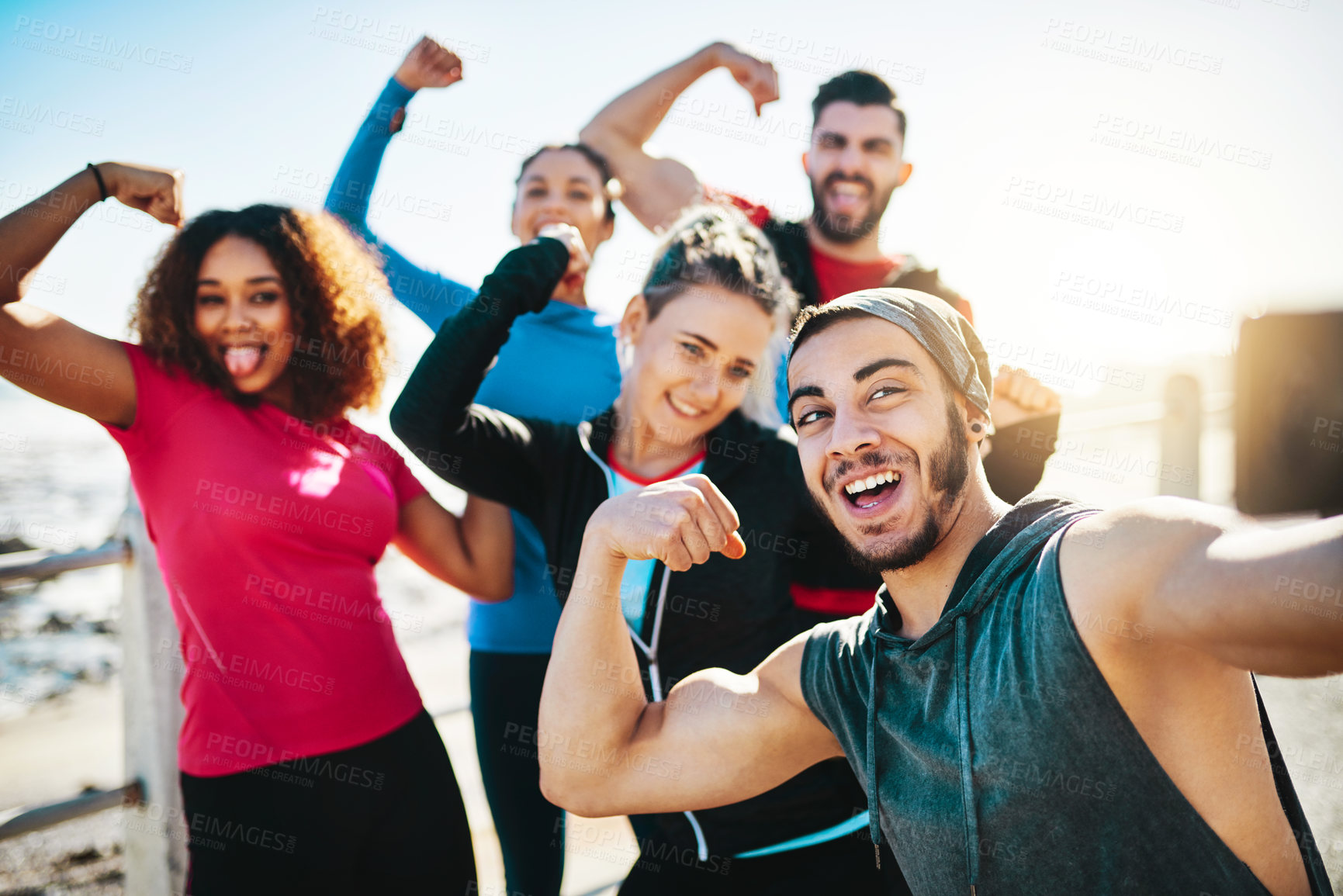 Buy stock photo Cropped shot of a fitness group taking a selfie while out for a run on the promenade