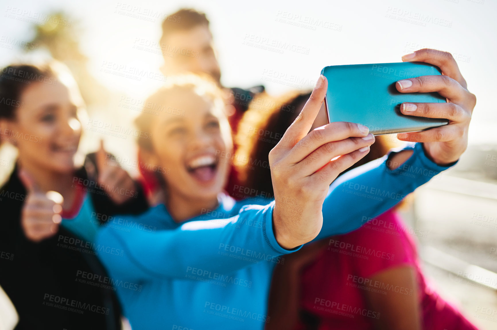 Buy stock photo Cropped shot of a fitness group taking a selfie while out for a run on the promenade