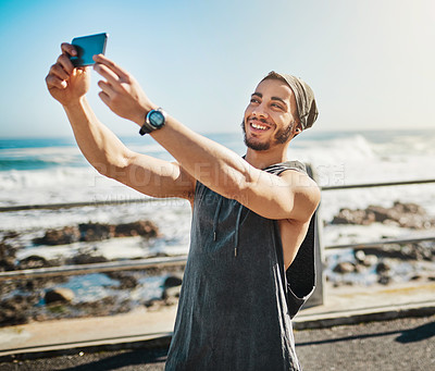 Buy stock photo Cropped shot of a man taking a selfie while out for a run on the promenade