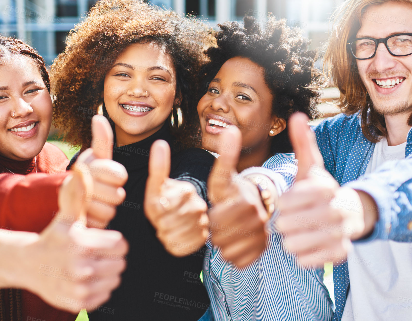 Buy stock photo Cropped portrait of a diverse group of college friends giving thumbs up while standing outside