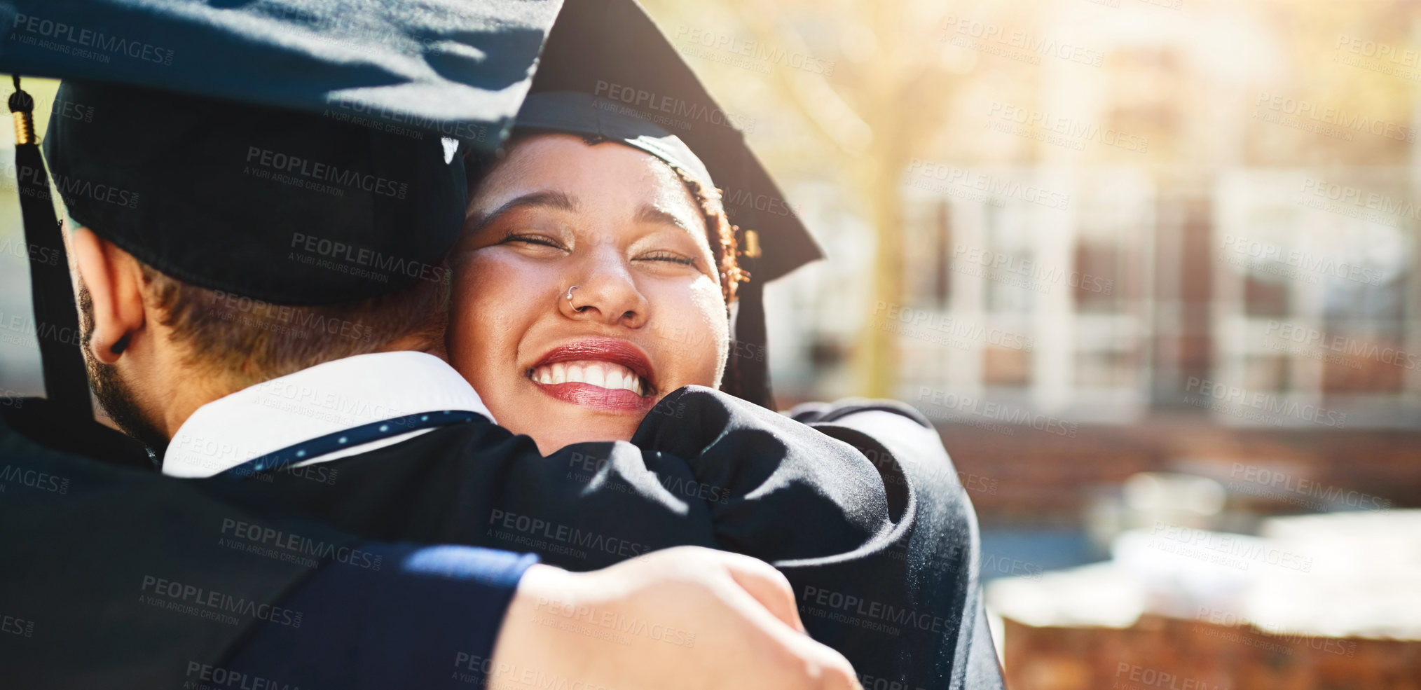 Buy stock photo Cropped shot of a young woman embracing her male friend after graduating