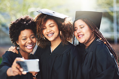 Buy stock photo Cropped shot of three students taking a selfie on graduation day