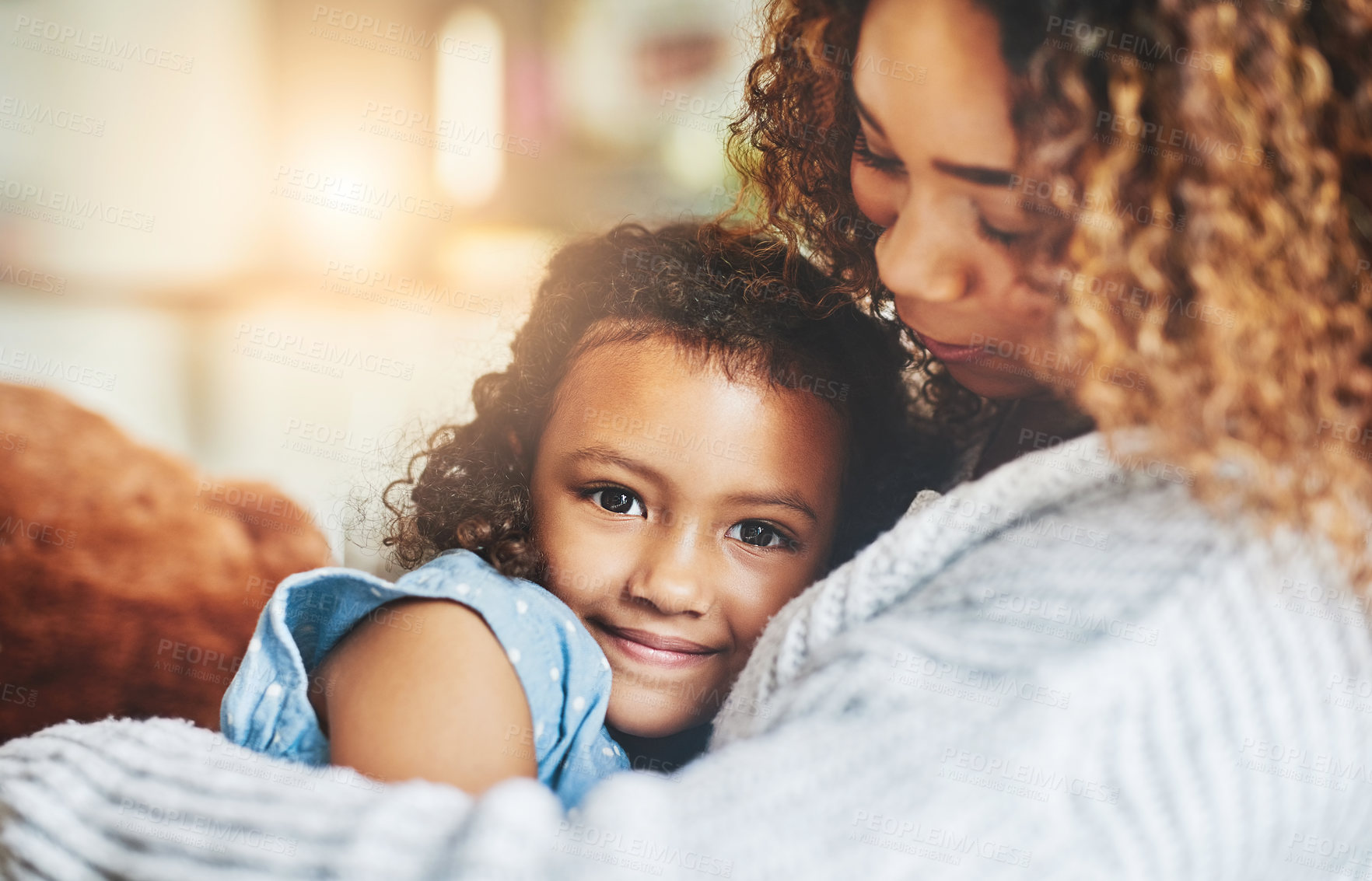 Buy stock photo Shot of an adorable little girl and her mother in a warm embrace at home