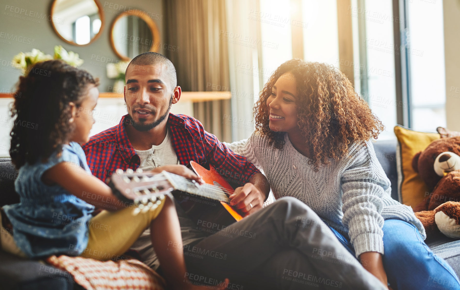 Buy stock photo Guitar, music and teaching with family in home living room together for bonding. Instrument, love or smile with mother, father and daughter in apartment for child development, learning or lesson