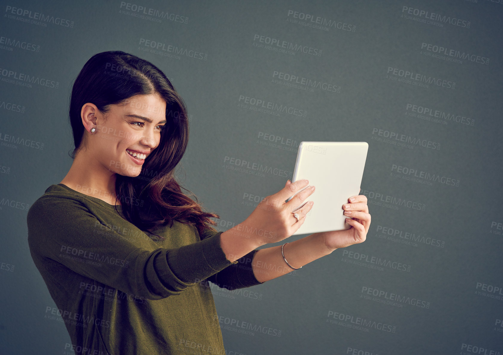 Buy stock photo Happy, woman and tablet in studio for video call, live stream and connectivity to internet. Influencer, smile and tech on gray background for selfie, follower interaction and social media update